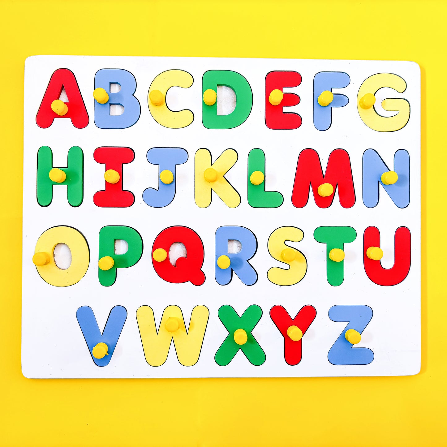 Colorful wooden alphabet puzzle with uppercase letters A to Z on a yellow background. The puzzle pieces have knobs for easy grasping. This educational toy helps young children learn the alphabet and letter recognition.