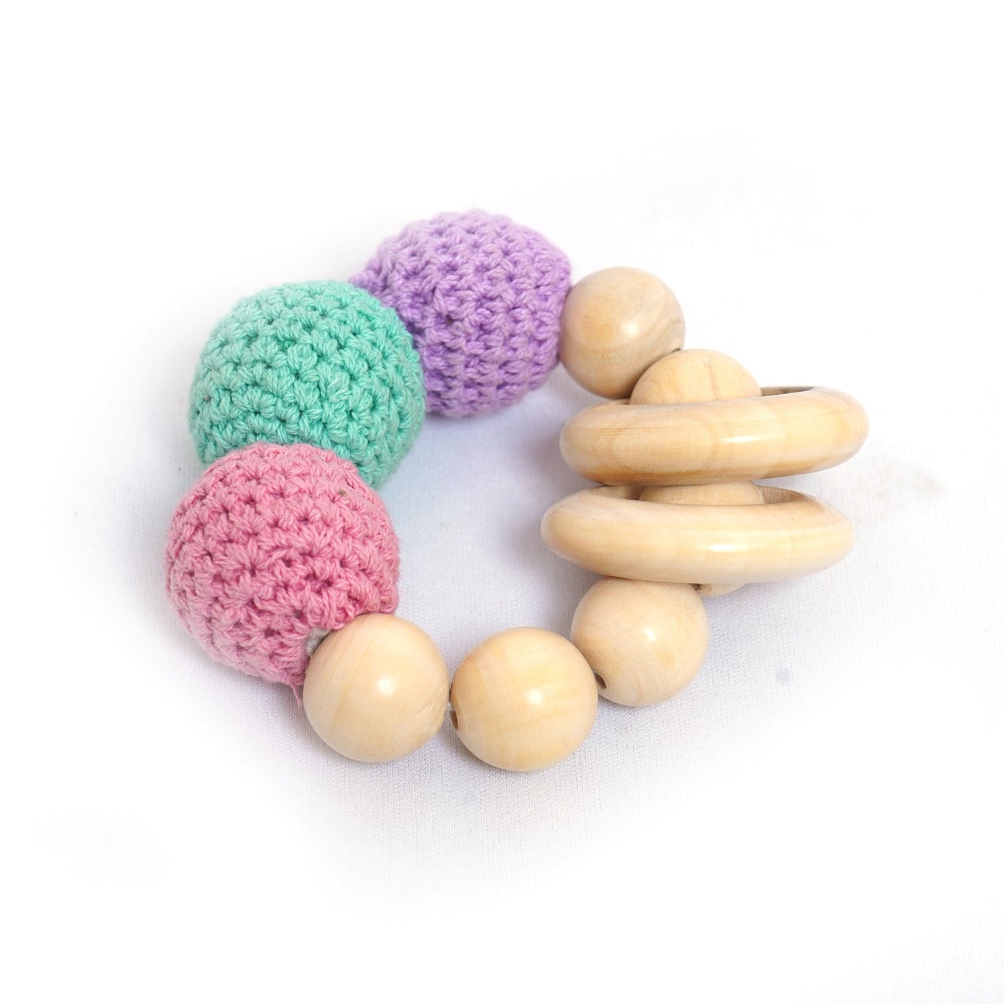Crochet teether toy with wooden beads and multicolored crocheted balls. This teething toy helps soothe babies' gums and promotes sensory development. 