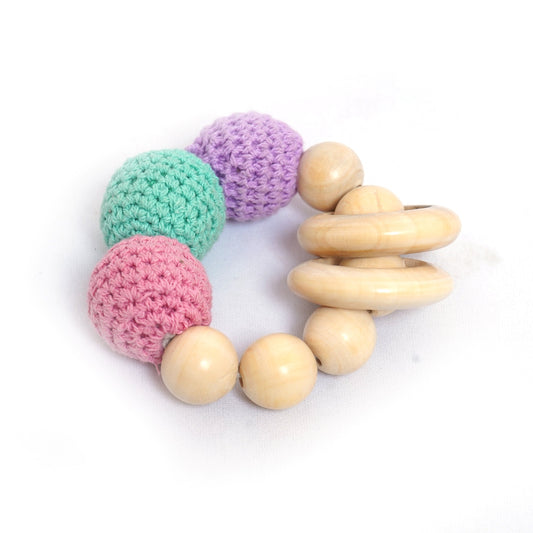 Crochet teether toy with wooden beads and multicolored crocheted balls. This teething toy helps soothe babies' gums and promotes sensory development. 