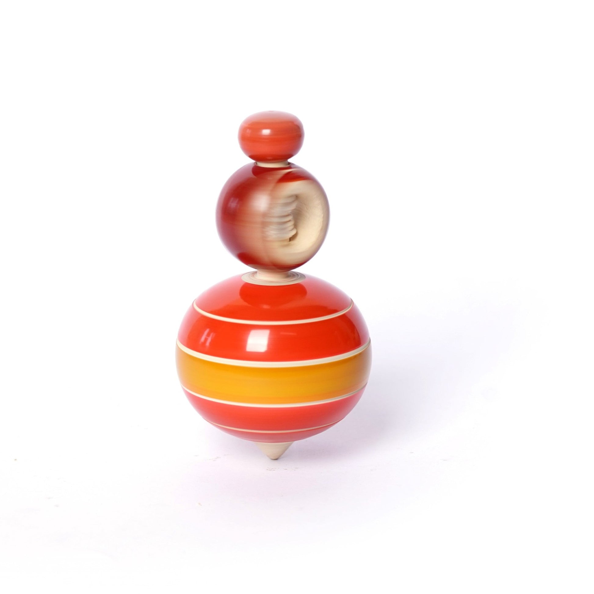 Red, yellow, and white wooden spinning top on a white background. This classic children's toy is a popular choice for toddlers and preschoolers