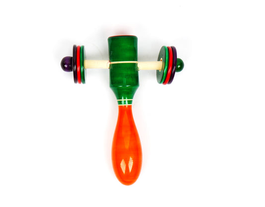 A colorful wooden rattle shaped like a bird with a yellow beak and a red body. The rattle has a handle and six rings in different colors.