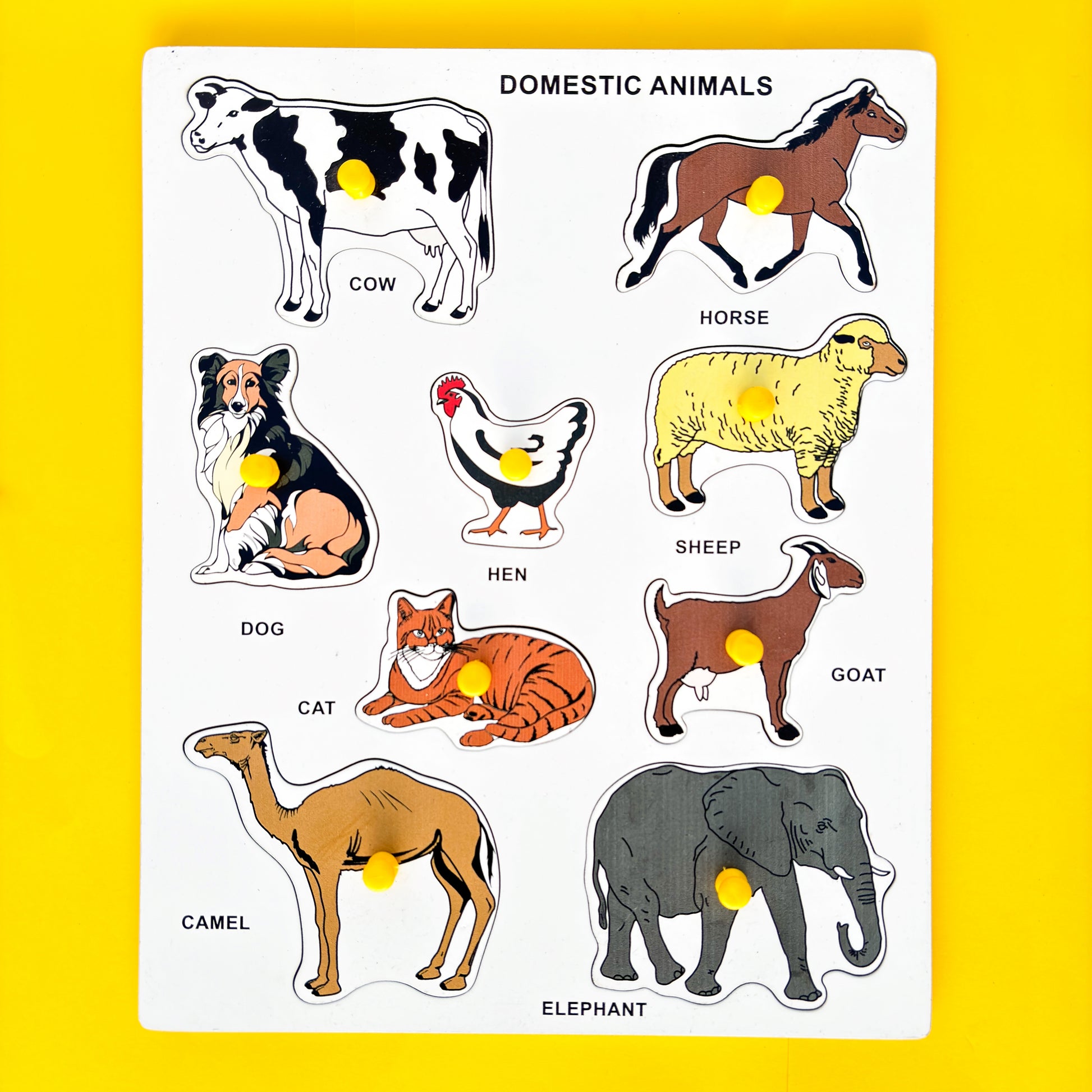 Wooden puzzle with colorful pictures of domestic animals on a yellow background. The text “DOMESTIC ANIMALS” is displayed at the top of the puzzle. Below the text, six animal names and their corresponding pictures are arranged in two rows.  In the first row, from left to right, are COW, HORSE, and HEN. In the second row, from left to right, are SHEEP, DOG, and CAT. Below these animals are GOAT and ELEPHANT.  This educational toy helps young children learn about different domestic animals. 